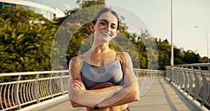 Happy girl posing before her morning jog. Morning exercise and active lifestyle