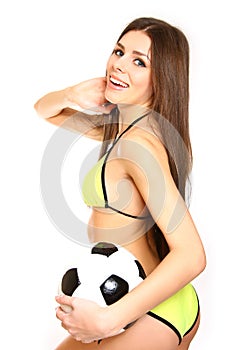 Happy girl posing with a soccer ball on a white background