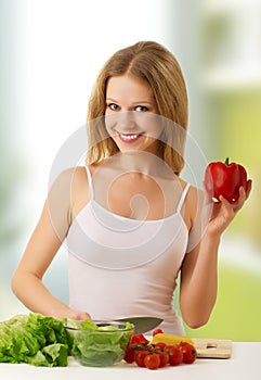 Happy girl preparing vegetarian food in kitchen