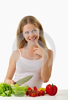 Happy girl preparing vegetarian food, vegetables