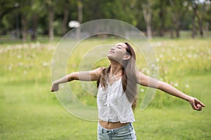 Happy girl refreshment in summer park