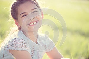 Happy girl resting at sunny meadow