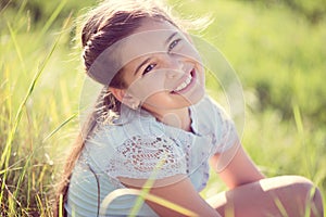 Happy girl resting at sunny meadow