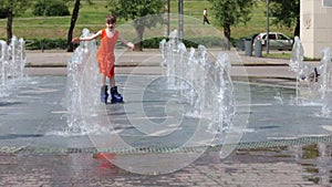 Happy girl roller skates in fountain in summer city