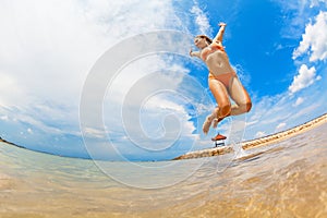 Happy girl run by wide sand beach