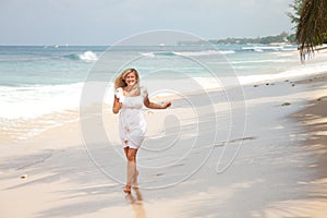 Happy girl running on the beach