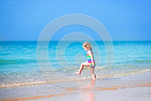 Happy girl running on a beach