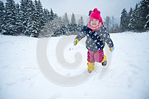Happy girl running over freshly fallen snow.