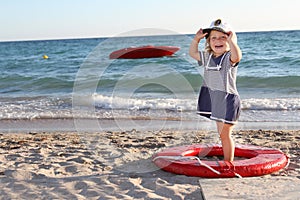 Happy girl in sailor hat on beach