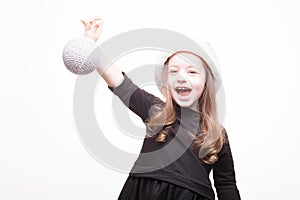 Happy girl in santa hat with christmas toys on white background. Funny young child waiting for christmas, new year and presents.