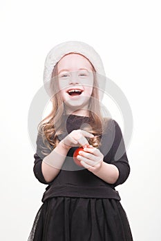 Happy girl in santa hat with gift on white background. Funny young child waiting for christmas, new year and presents. holiday,