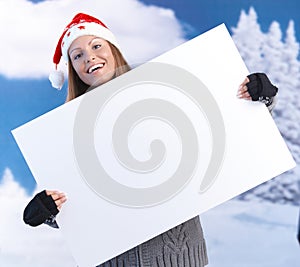 Happy girl in santa hat holding huge letter