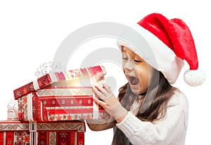 Happy Girl in Santa Hat Opening a Gift Box