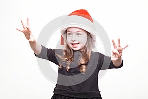 Happy girl in santa hat on white background. Funny young child waiting for christmas, new year and presents. holiday, sale concept