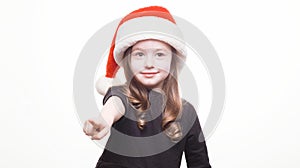 Happy girl in santa hat on white background. Funny young child waiting for christmas, new year and presents. holiday, sale concept