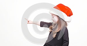 Happy girl in santa hat on white background. Funny young child waiting for christmas, new year and presents. holiday, sale concept