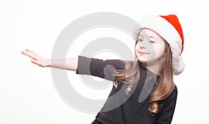 Happy girl in santa hat on white background. Funny young child waiting for christmas, new year and presents. holiday, sale concept
