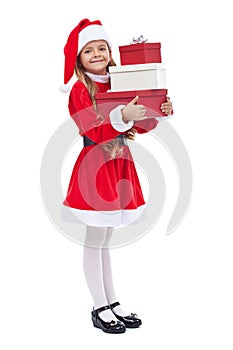 Happy girl in santa outfit holding presents photo