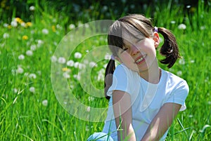 Happy girl sat in field