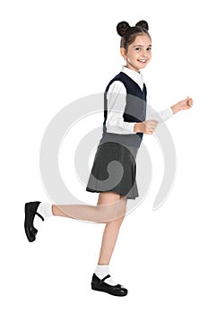 Happy girl in school uniform walking on  background