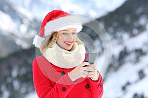 Happy girl sending christmas messages on phone