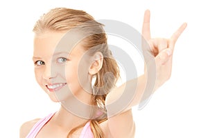 Happy girl showing devil horns gesture