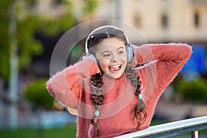Happy girl singing to music. Melomaniac girl singing song outdoors