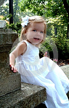 Happy Girl Sitting in Garden