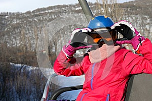 Happy girl in ski goggles looks away during photo
