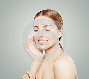 Happy girl smiling. Pretty young woman with clear healthy skin smiling on white background