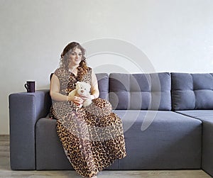 Happy girl the sofa teddy bear toy tenderness emotions holding relax