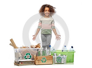 happy girl sorting paper, metal and plastic waste