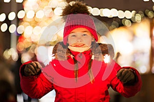 Happy girl with sparklers at christmas market