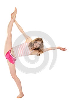 Happy girl in sportswear does gymnastic exercise