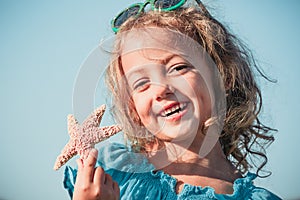 Happy girl with starfish