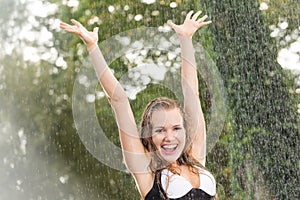 Happy girl in summer rain