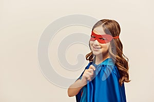 happy girl in superhero costume with