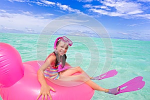 Happy girl swimming in ocean