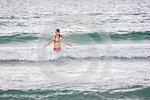 Happy girl swims alone in the sea
