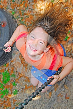 Happy girl on swing photo
