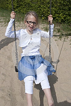 Happy girl on swing