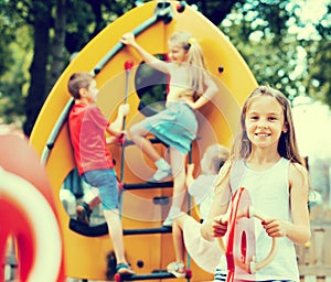 Happy girl swinging at playground