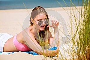 Happy girl taking selfie photo on beach.