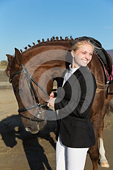 Happy girl teenager with his horse