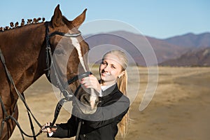 Happy girl teenager with his horse