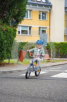 Happy girl to ride public bike on one of traffic playground in Prague, Czech republic