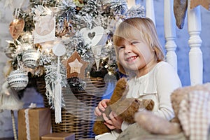 Happy girl with toy bear. Christmas.