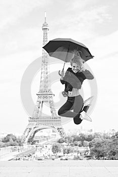 Happy girl travel in paris, france. Woman jump with fashion umbrella. Parisian on white background. Woman with