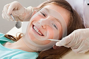 Happy girl undergoing dental treatment