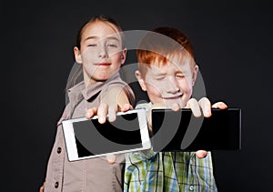 Happy girl and unhappy boy, children show mobile phone screen